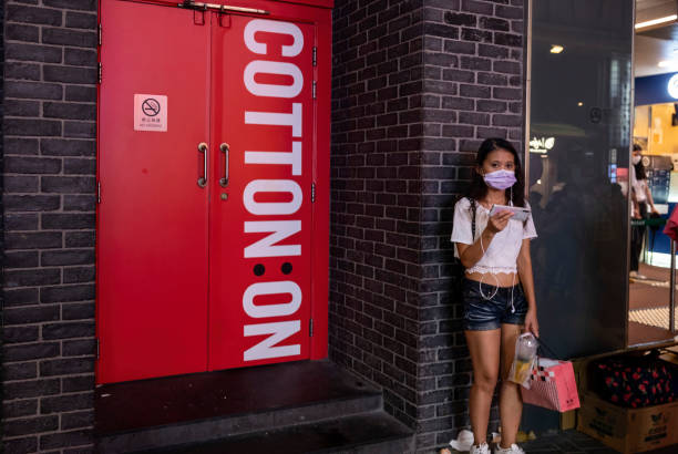 woman stands outside the australias largest clothing retailer cotton picture