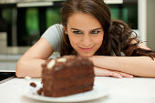 Woman staring at chocolate cake