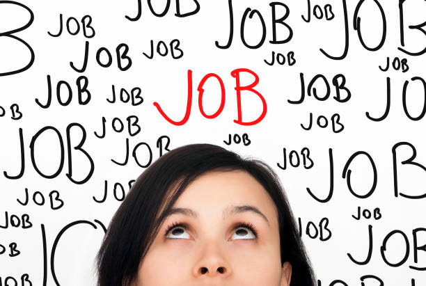 a woman thinking about a job with the word job over her head - vacature stockfoto's en -beelden