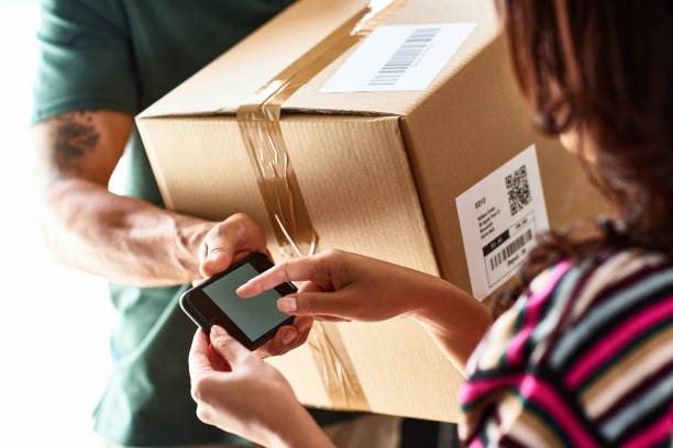 woman using smartphone to sign for parcel delivery picture