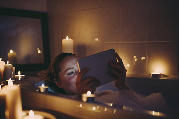 woman using tablet pc in bathtub. - take a bath stock pictures, royalty-free photos & images
