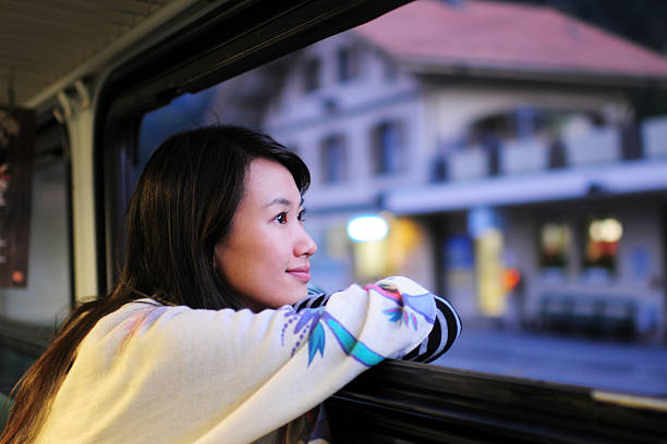woman waiting and looking through window - xlarge - asian woman looking at the left side stock pictures, royalty-free photos & images
