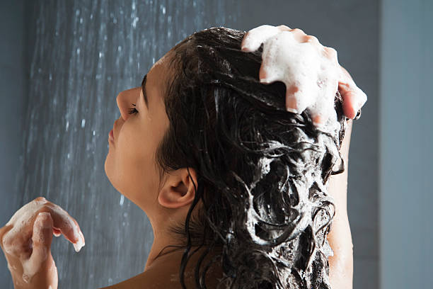 woman washing her hair in shower - wash hair stock pictures, royalty-free photos & images