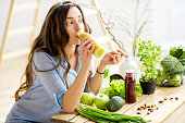 Woman with green healthy food at home