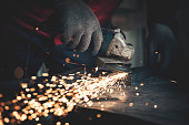 Worker grinding metal close up shot
