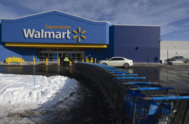 worker pulls shopping carts outside a walmart store in montreal on picture