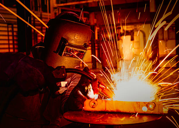 worker welding in factory