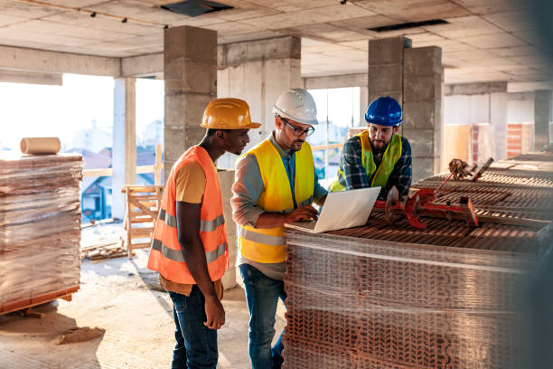 workers at construction job site inside building - construction wifi stock pictures, royalty-free photos & images