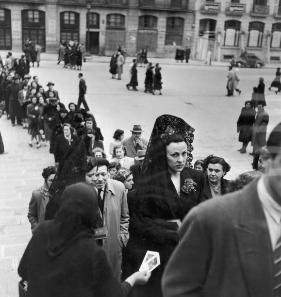 Worshippers filing into Barcelona's great cathedral, Santa Eulalia, on Good Friday, 14th April 1951. Two ladies are wearing the traditional mantilla....