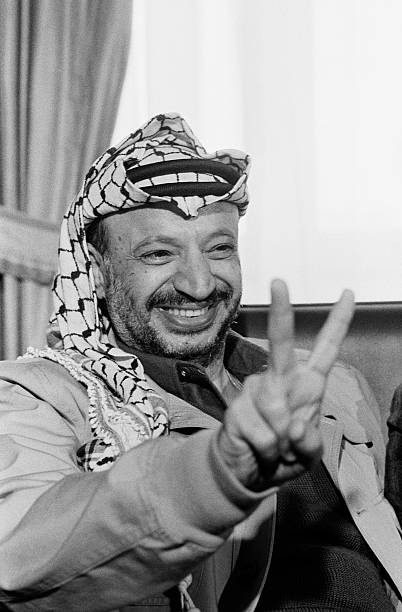 Image result for 1988 â PLO ChairmanÂ Yasser ArafatÂ gives a speech at a UN General Assembly meeting in Geneva, Switzerland,