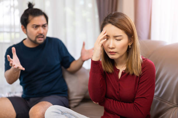 young asian couple arguing each other on sofa at home, divorce, depressed person - asian couple breaking up stock pictures, royalty-free photos & images