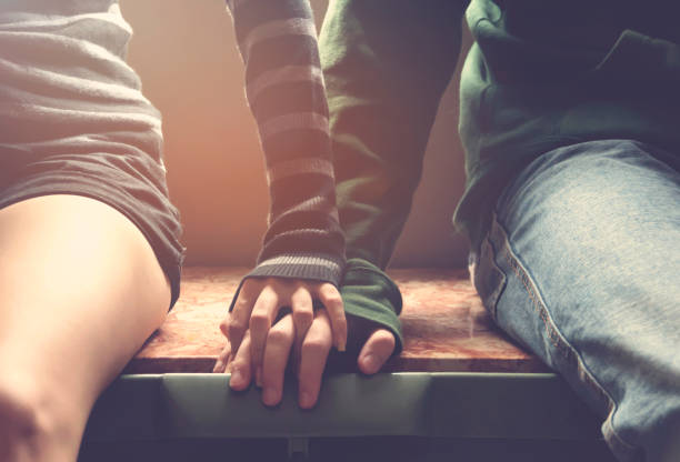 young couple holding hands - couple  stock pictures, royalty-free photos & images