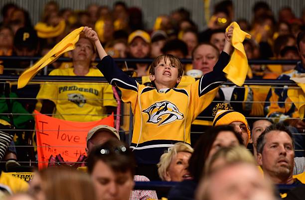 Young fan of the Nashville Predators waves rally towels during the first period in Game Six of the Western Conference First Round against the Anaheim...