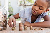 Young girl counting her coins.