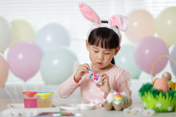 Young Girl Making Easter Craft At Home