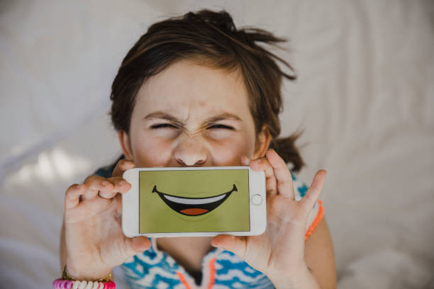 young girl pulling a funny face with smartphone over her mouth picture id832280250?k=20&m=832280250&s=612x612&w=0&h=tx4YRldKVskOok aCYR EBQyCb rsj