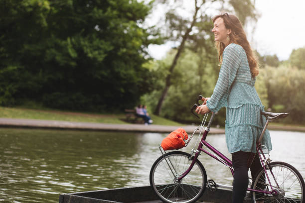 Young lady out in the park at dusk with her vintage bicycle