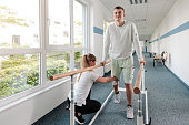 Young man in walking rehabilitation course after a sport injury