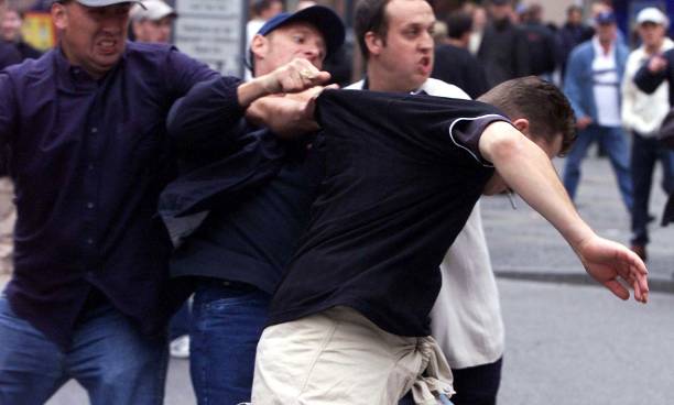A young man is attacked as trouble flares between German and English supporters, in the centre of Munich, Germany ahead of the World Cup qualifying match between Germany and England at the Olympic Stadium in Munich.