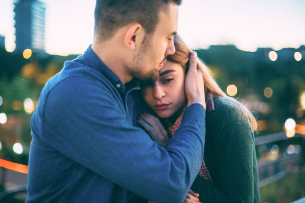 young man supporting his girlfriend after panic attack - couple hug stock pictures, royalty-free photos & images