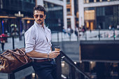 Young stylish businessman having takeaway coffee