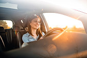 Young woman driving car on a sunny day