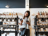 Young woman holding jars in zero waste store