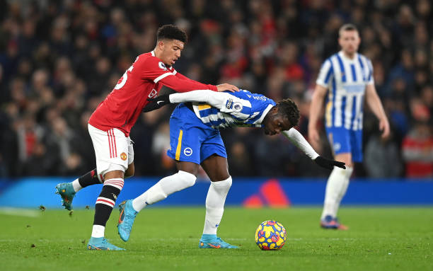 Yves Bissouma of Brighton & Hove Albion is challenged by Jadon Sancho of Manchester United during the Premier League match between Manchester United...