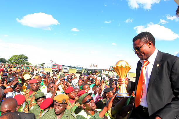 Zambia national football team captain Christopher Katongo holds on February 13 2012 the trophy of the 2012 Africa Cup of Nations upon arrival from...