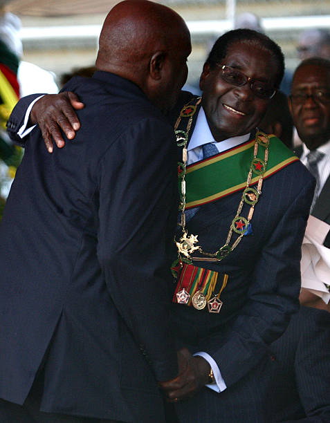 Zimbabwean President Robert Mugabe is congratulated by former Zambian President Kenneth Kaunda during Mugabe's inauguration ceremony and swearing in...