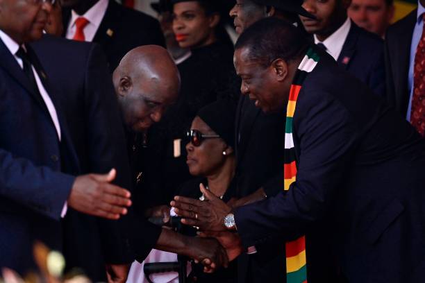 Zimbabwe's President Emmerson Mnangagawa receives Zambia's former president Kenneth Kaunda on September 14 during the farewell ceremony for the late...