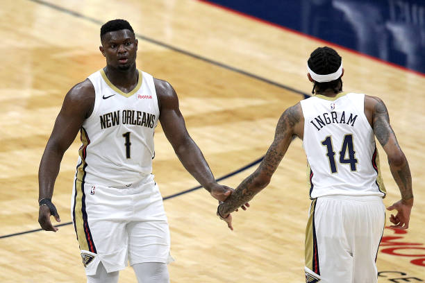 Zion Williamson of the New Orleans Pelicans and Brandon Ingram of the New Orleans Pelicans react after scoring during the third quarter of an NBA...