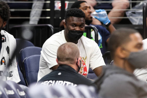 Zion Williamson of the New Orleans Pelicans looks on from the bench in the fourth quarter of a preseason game against the Minnesota Timberwolves at...