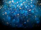 Christmas and New Year template with white blurred snowflakes, glare and sparkles on blue background. EPS 10
