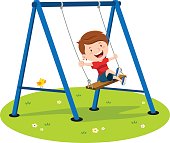 Cute boy playing on swing