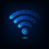 Futuristic glowing low polygonal wifi symbol isolated on dark blue background.