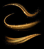 Golden shimmering waves with light effect isolated on black background.