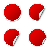 Set of red round adhesive stickers with a folded edges, isolated on white background.