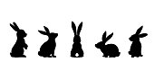 Silhouettes of easter bunnies isolated on a white background. Set of different rabbits silhouettes for design use.