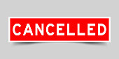 Square red color sticker with word cancelled on gray background