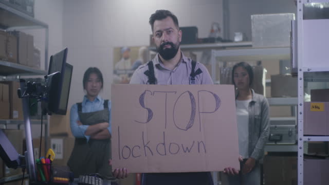 Man holding anti-lockdown message