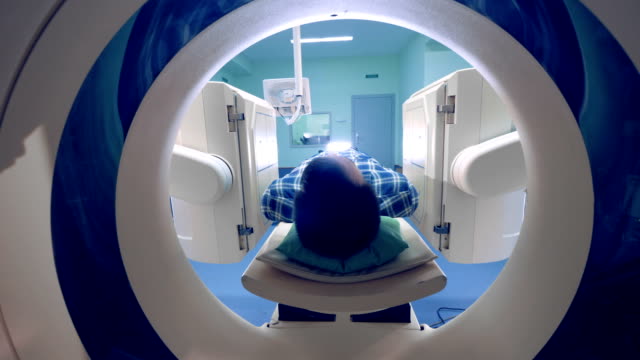 A person in a tomographic scanner. Tomograph, Patient on magnetic resonance imaging.